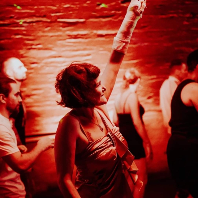 An audience member dancing with their arm in the air at our sober rave at Basement 45