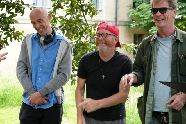 Rising Voices singers smiling in the gardens of St George's before their performance for Singing City 2025.