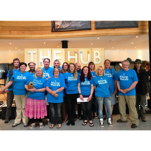 Rising Voices smiling standing inside the Millennium Centre after their performance at the Festival of Voices in 2018