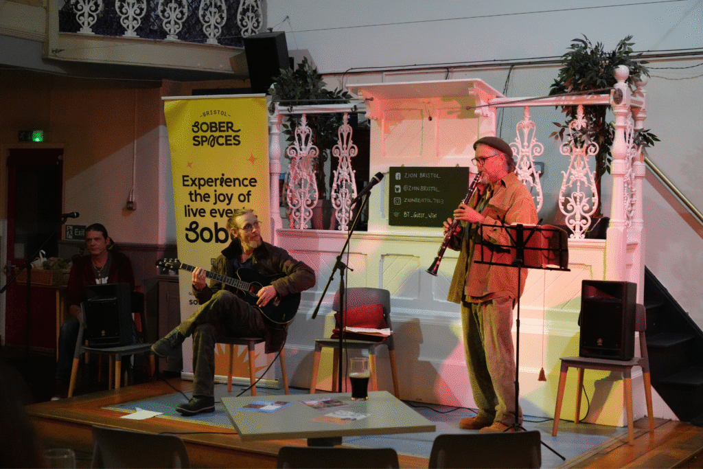 Clarinettist and guitarist performing at a Bristol Sober Spaces open mic at Zion Cafe.