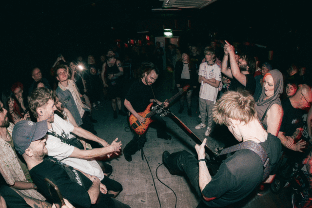 A guitarist playing in the crowd with a circle around him at the sober metal night at Rough Trade