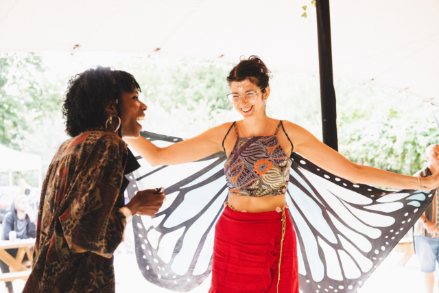 An audience member at the sober day rave dancing wearing a butterfly wing coat