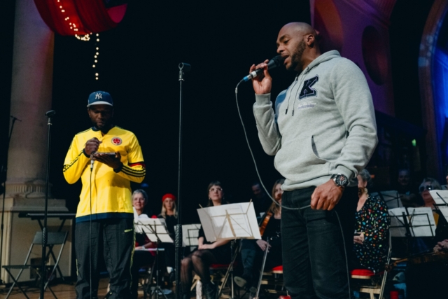 Two group members of Hip Hop garden performing onstage at the gala