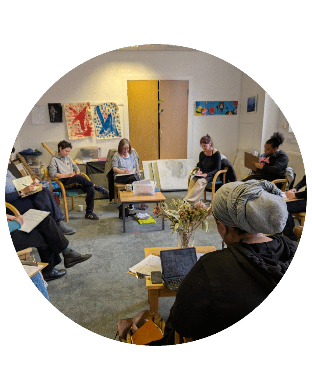 The creative writing group sat in a circle writing.
