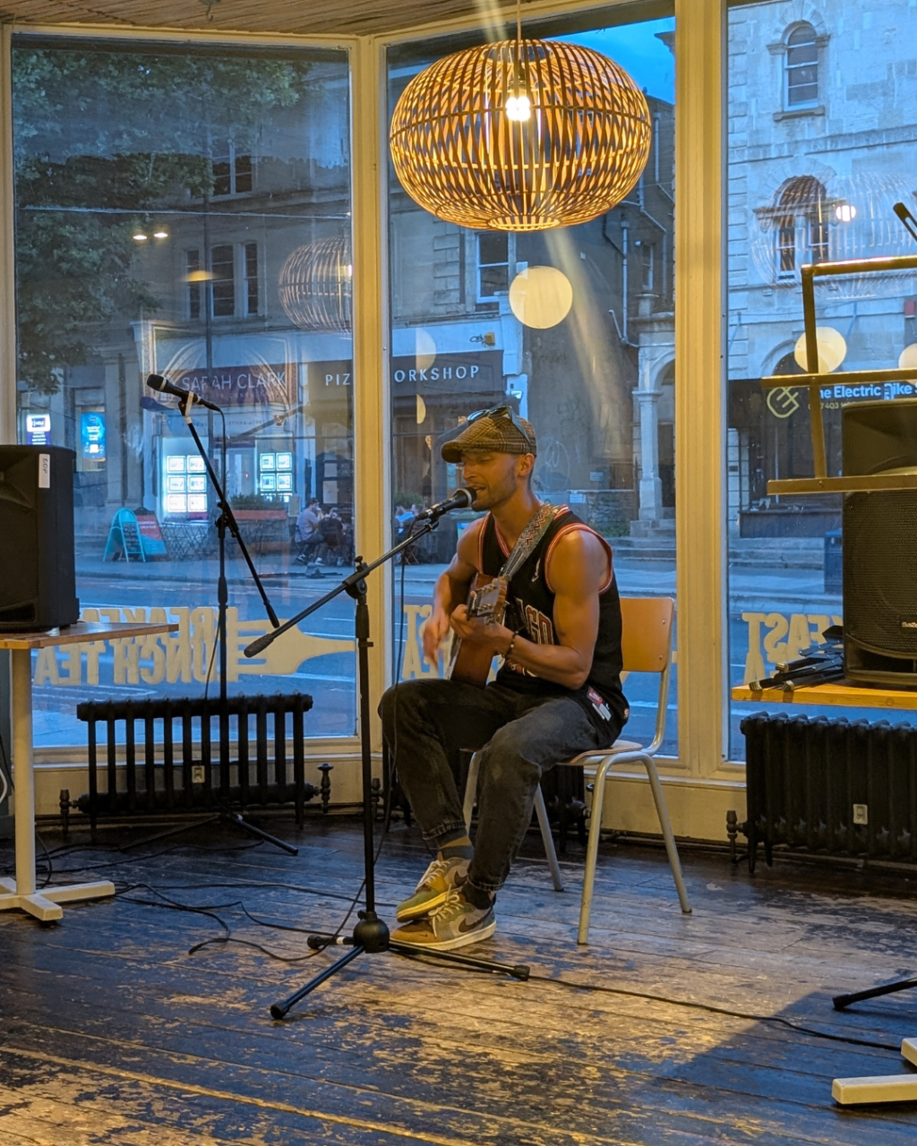 Open mic performer playing the guitar and singing